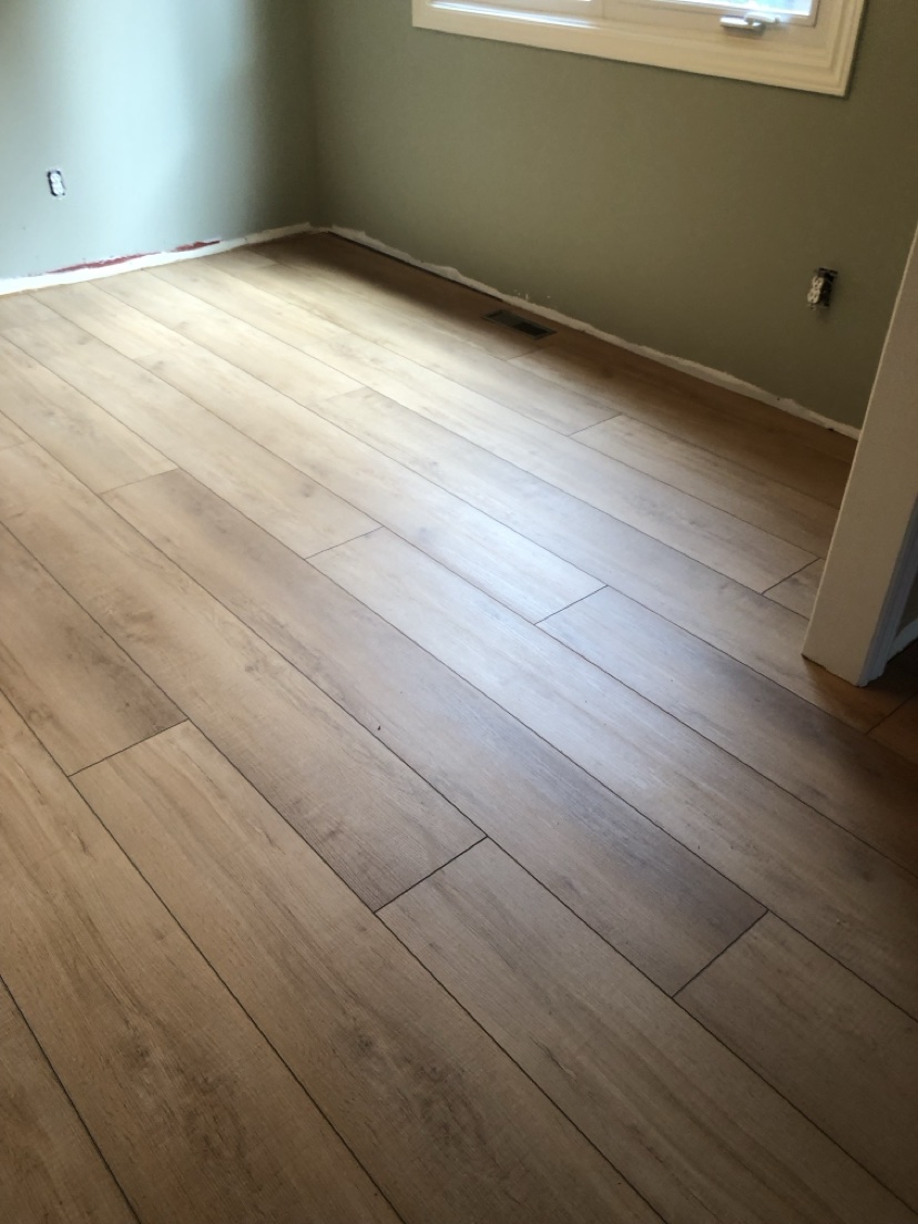 Sunlit room with a light natural oak floor installed by Hearth & Plank