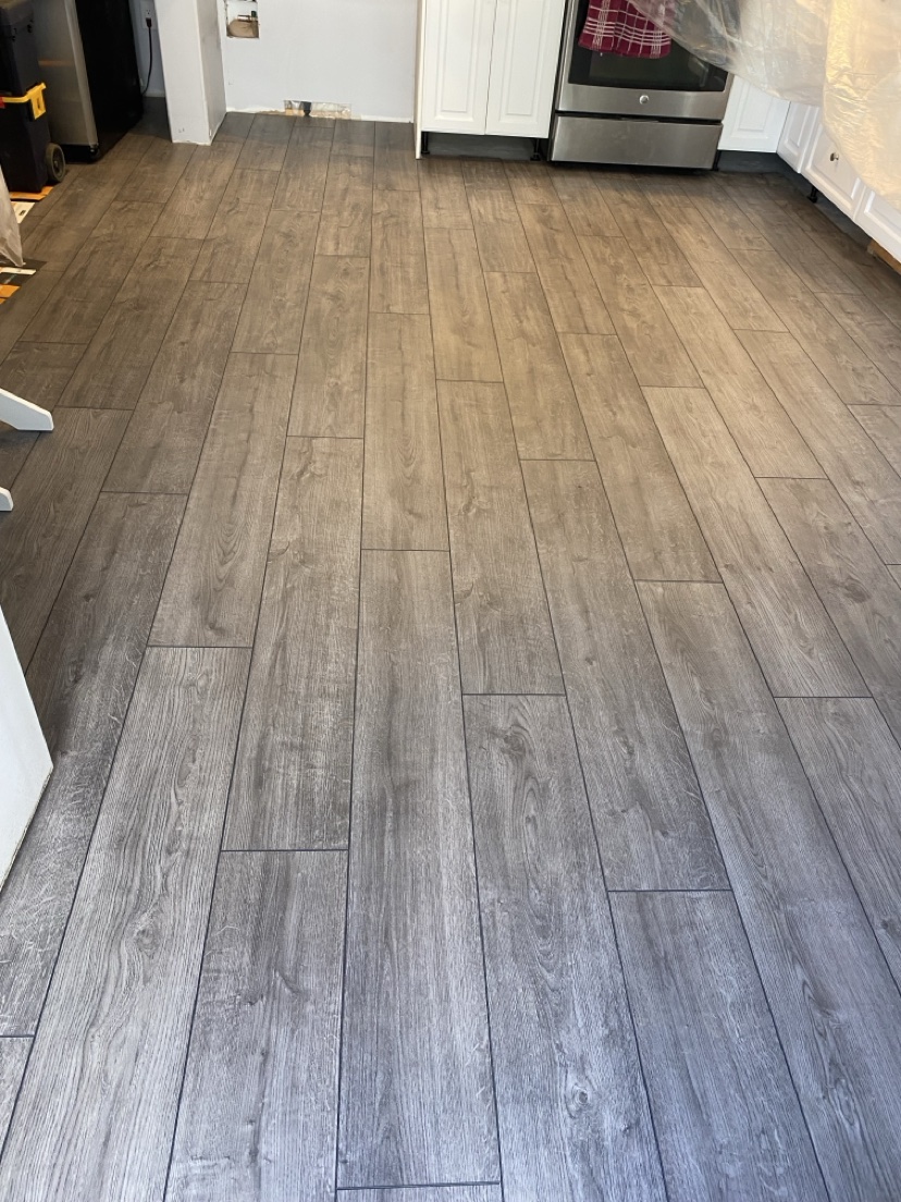 Kitchen with a medium warm-brown plank floor installed by Hearth & Plank