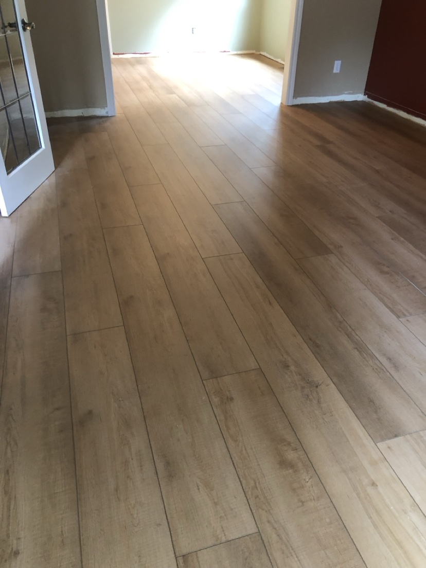 Open living space with a light natural plank floor installed by Hearth & Plank